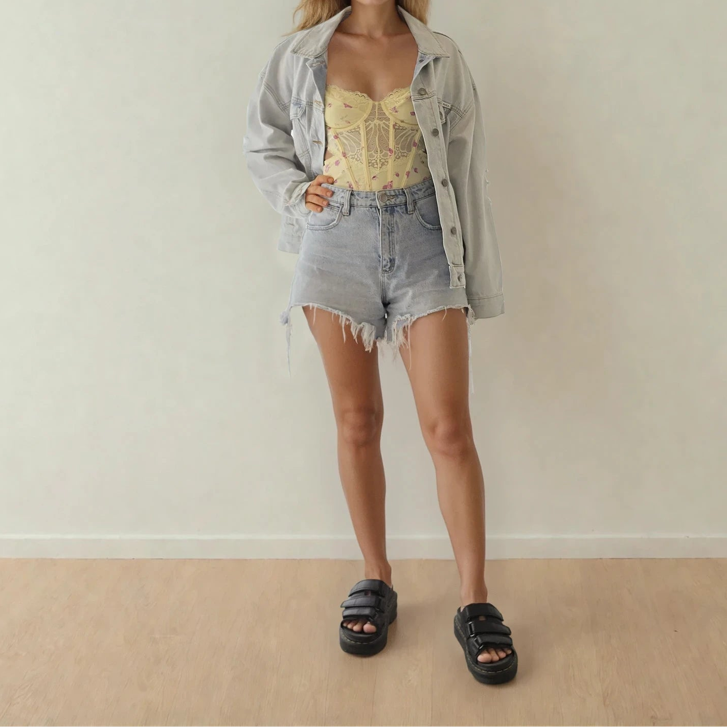 Front view of the RVCA light wash denim jacket, showing the button front and collared neckline.