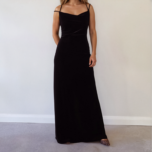 Front view of model wearing the black Saba velour floor-length maxi dress with spaghetti straps and a cowl neckline.