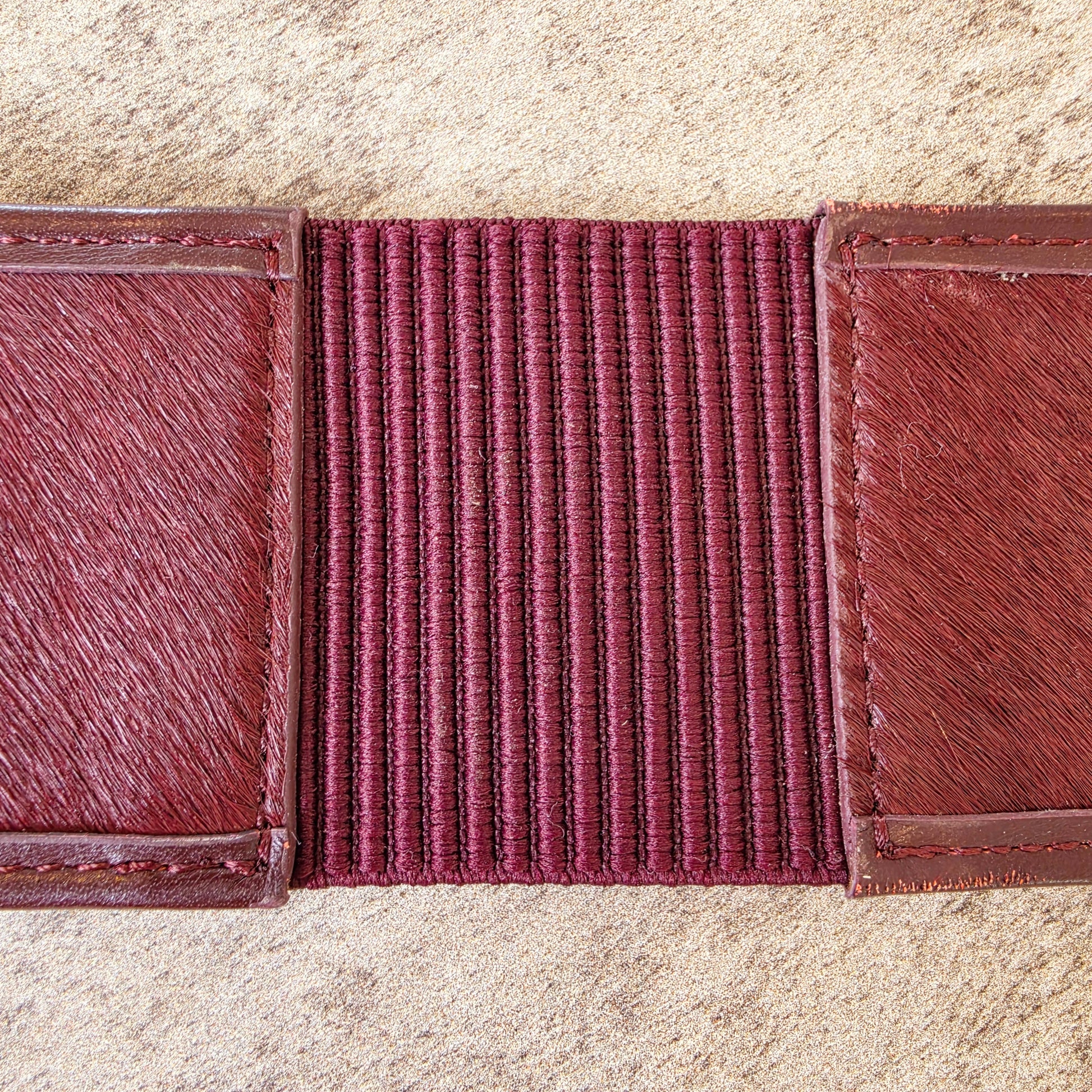 Back view of the inside of the Sass & Bide western style belt, showing the outside back stretch panel. This image also shows the imperfections on the leather near the stitching.