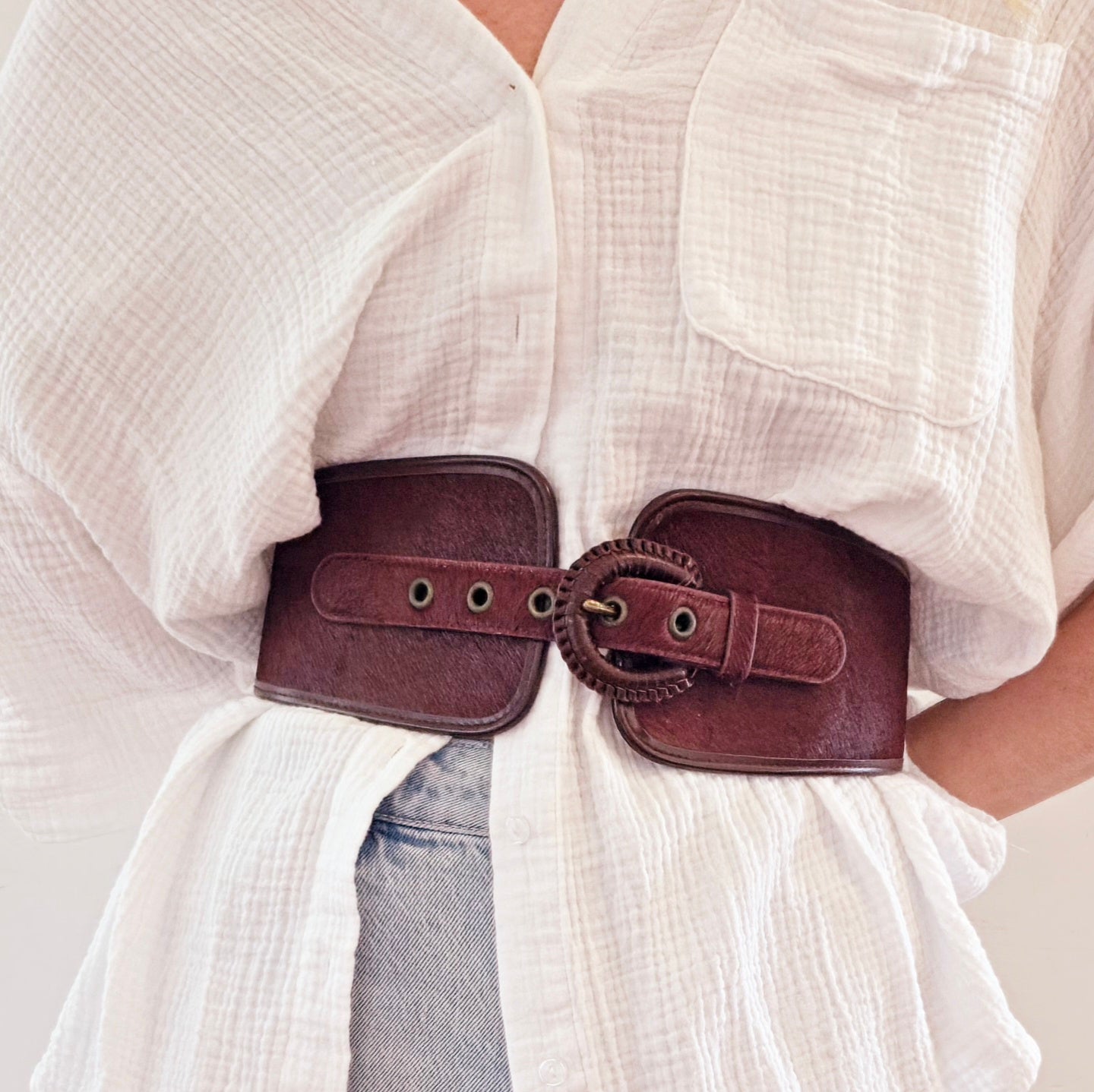 Image showing model wearing the Sass & Bide western inspired belt made of leather and horsehair in a burgundy ox blood colour.