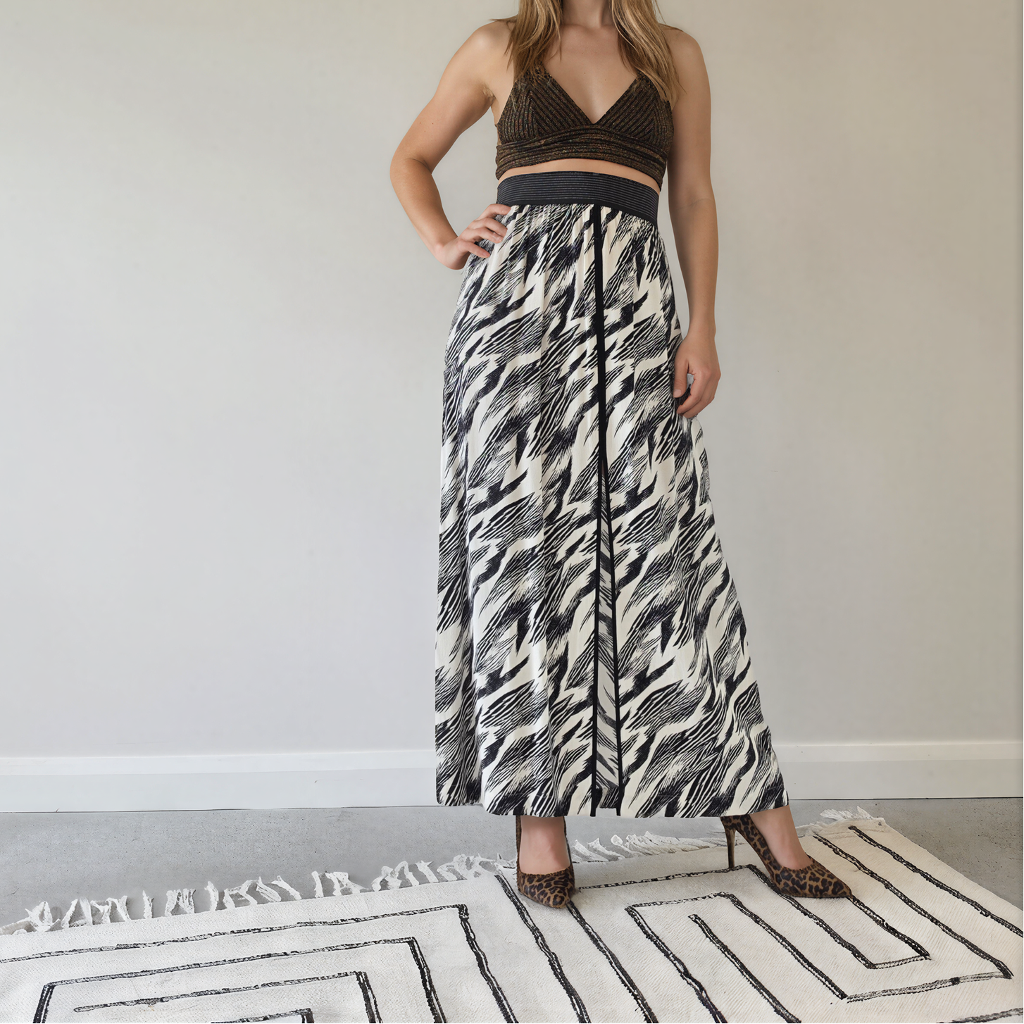 Front view of model wearing the Sass & Bide Bird of a Feather skirt, showing the monochrome print, front, spilt and wide metallic stripe waistband