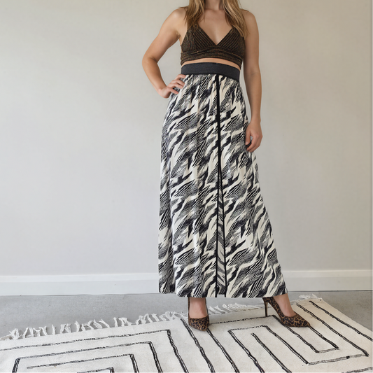 Front view of model wearing the Sass & Bide Bird of a Feather skirt, showing the monochrome print, front, spilt and wide metallic stripe waistband