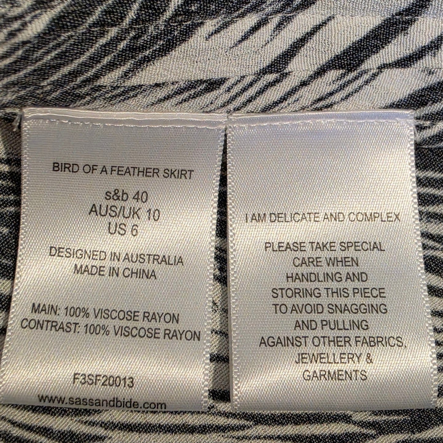 Image of the garment care labels inside the Sass & Bide Birds of a Feather skirt, showing the size 40 AUS/UK 10 & US 6
