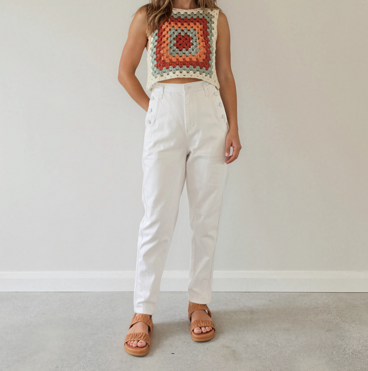 Women wearing the white Sass & Bide Jean, showing the front view with the button side details and ankle length.