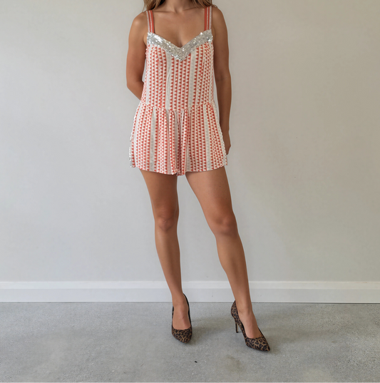 Front view of model wearing the Lost Weekend playsuit by Sass& Bide, showing the geometric pattern and sequin details.