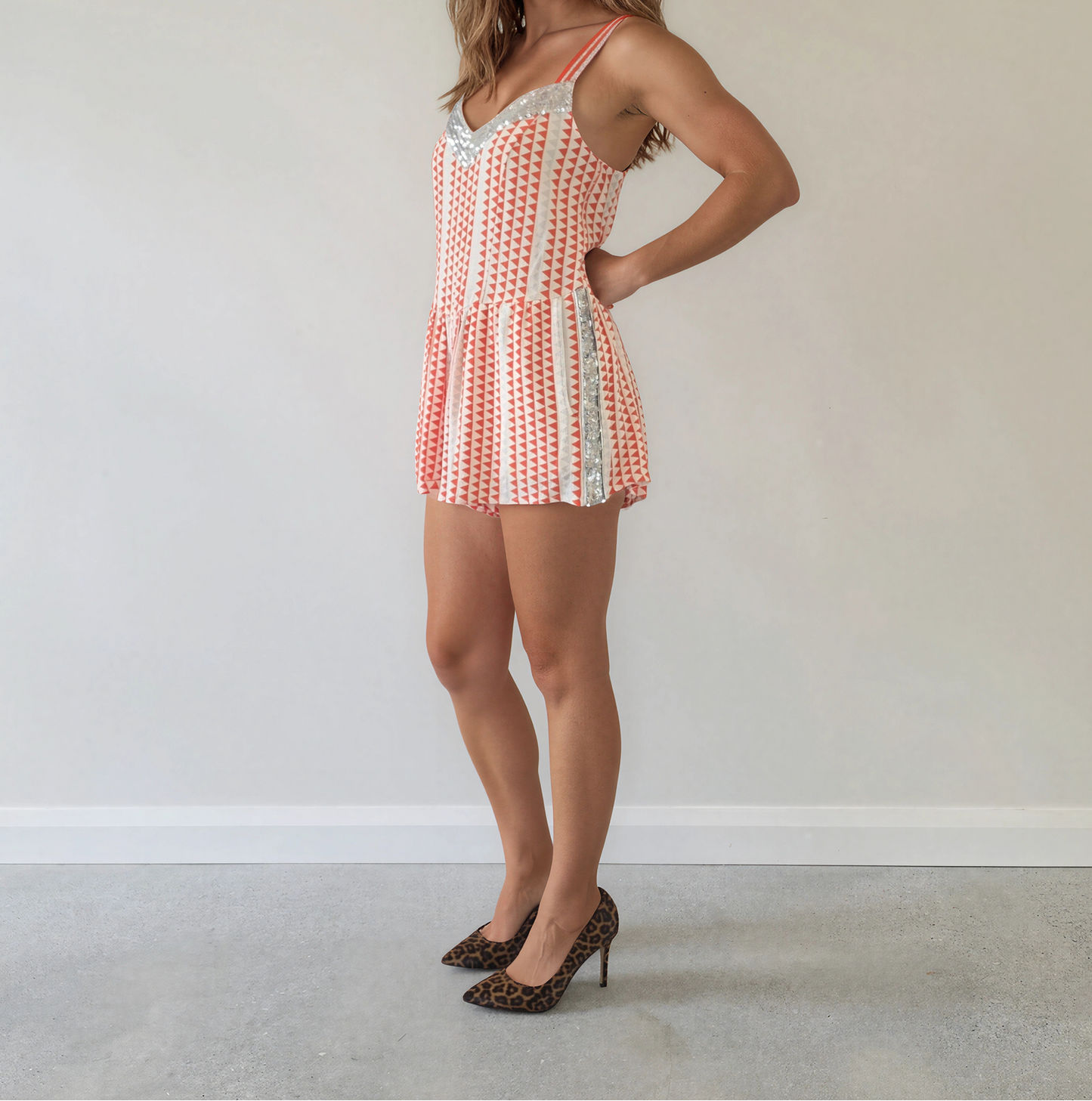 Side view of model wearing the Lost Weekend playsuit by Sass & Bide, showing the geometric pattern and sequin details.