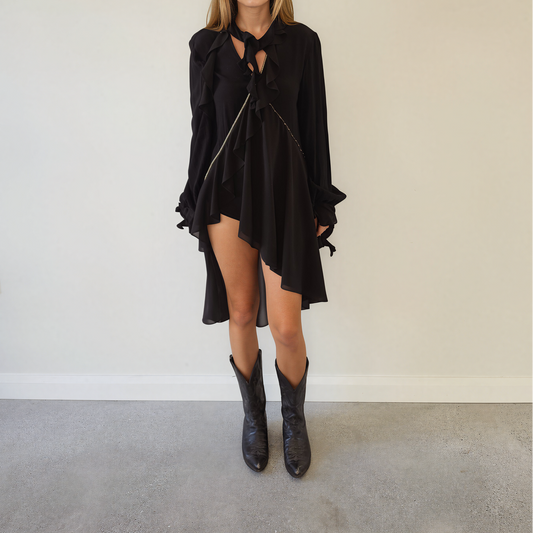 Front view of women wearing the sass and bide made for love top, showing the asymmetrical hemline, tie neck and  embellished details
