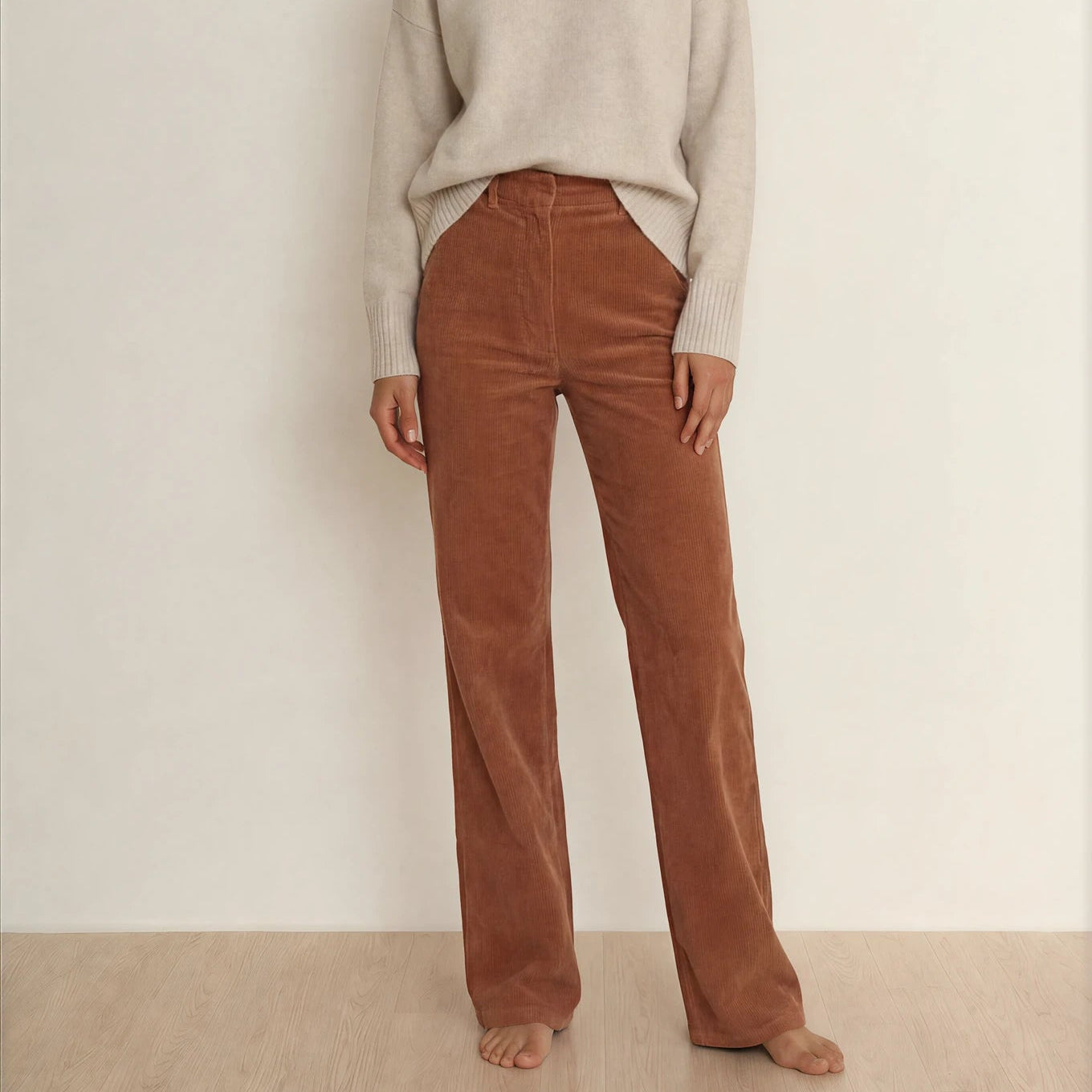 Front view of model wearing the Scanlan Theodore high waisted cords, with a beige coloured jumper.