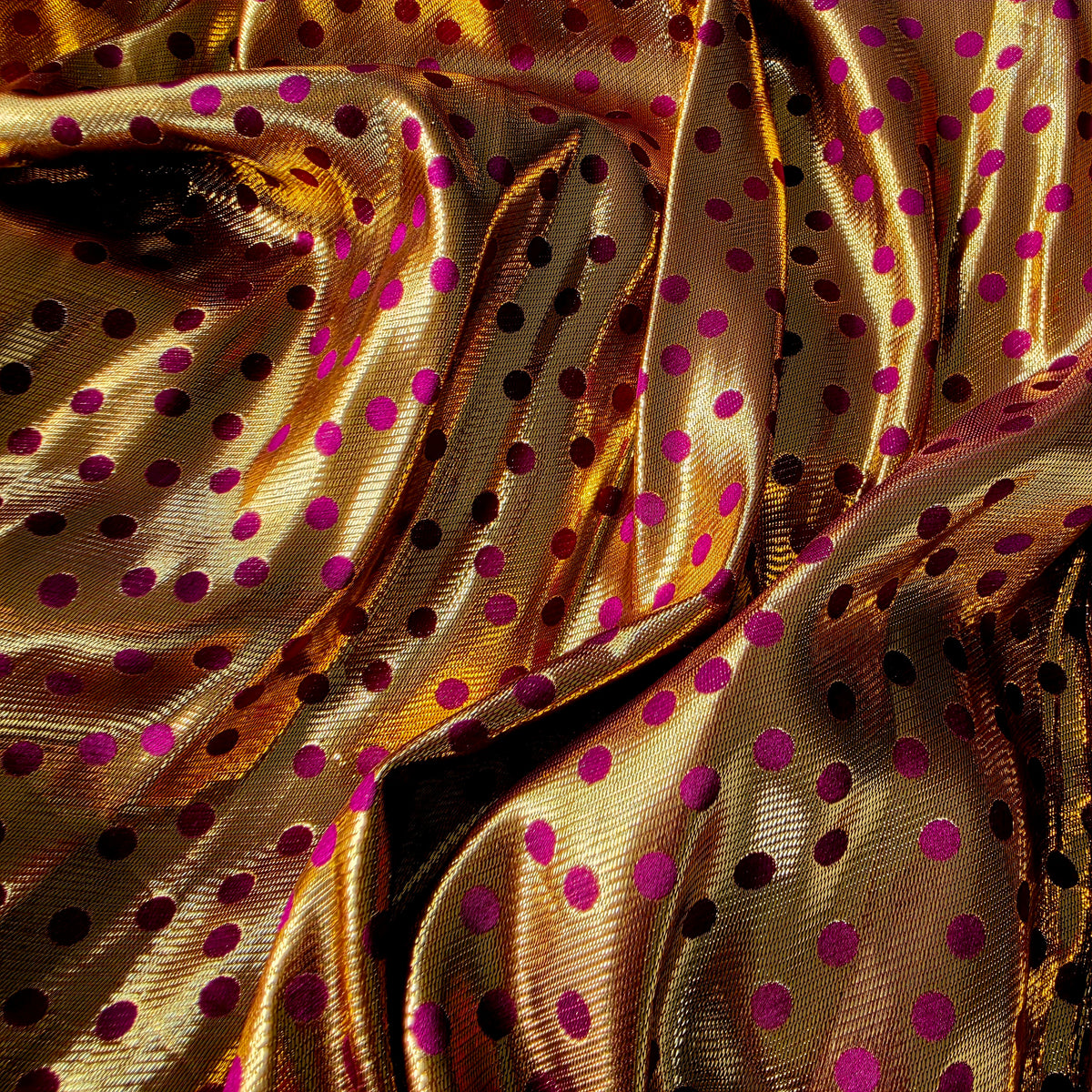 Close-up of burgundy satin fabric with metallic gold polka dot jacquard on the Scotch & Soda Magnifique duster.