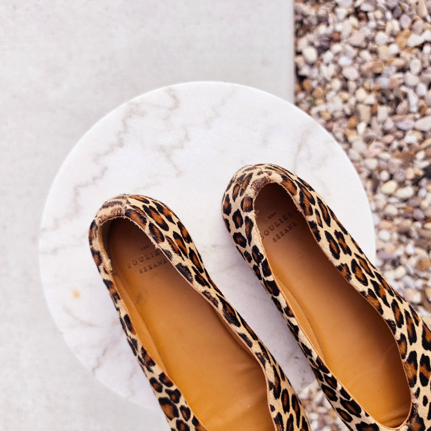 Top view of Sézane leopard pony hair ballerinas showing the brand name