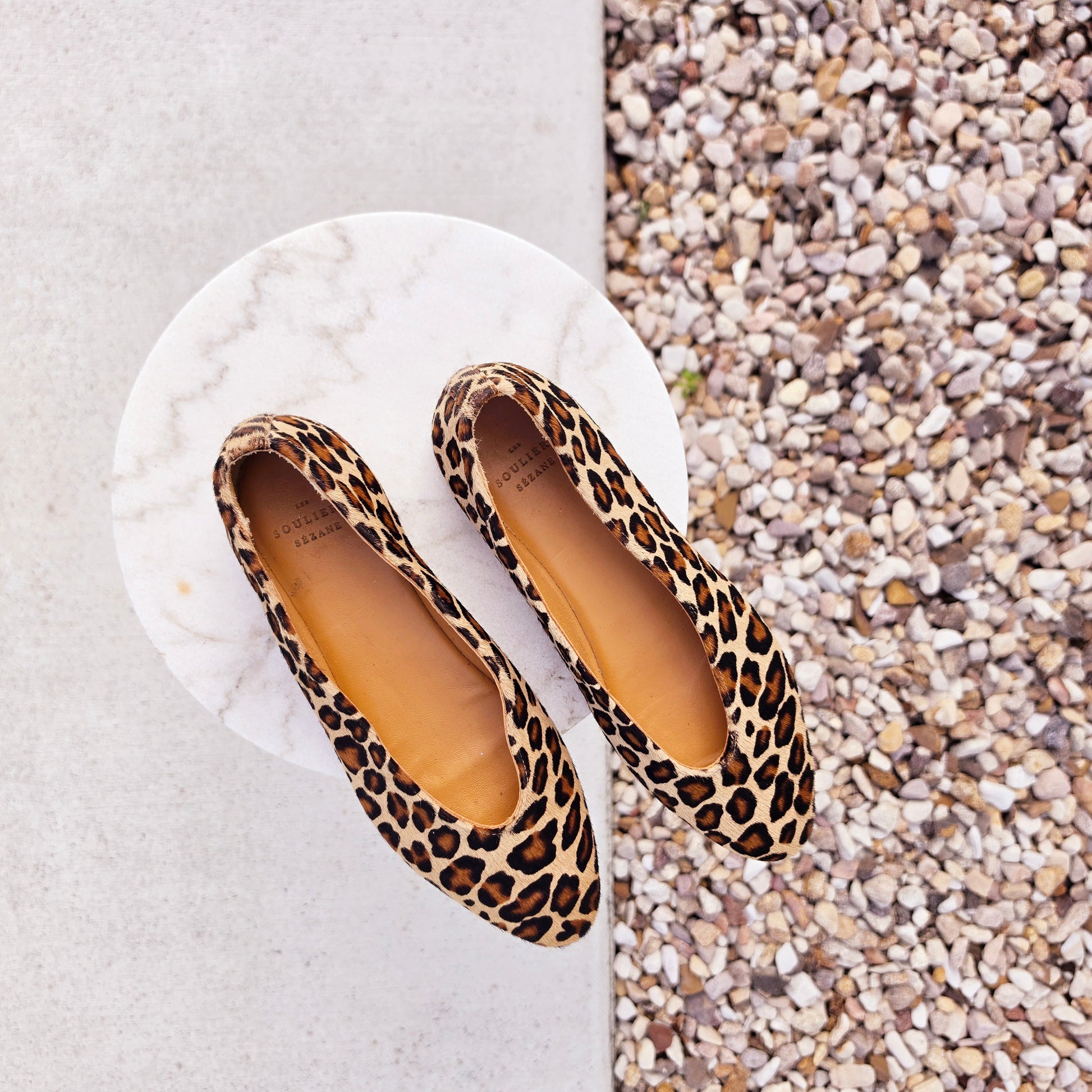Top view of Sézane leopard pony hair ballerinas