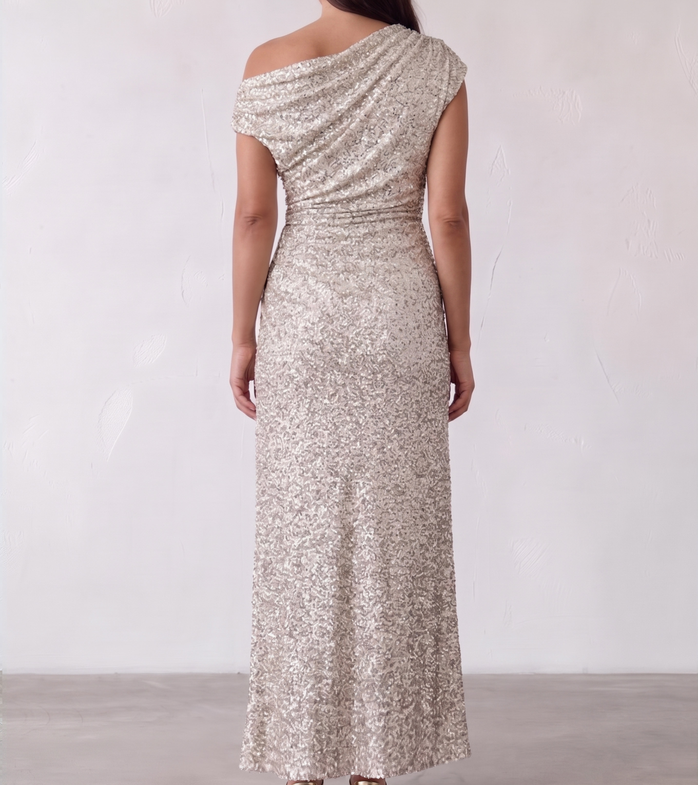 Image showing the back view of the Sheike Martina Maxi dress, showing the draped shoulder and full silver sequin floor length
