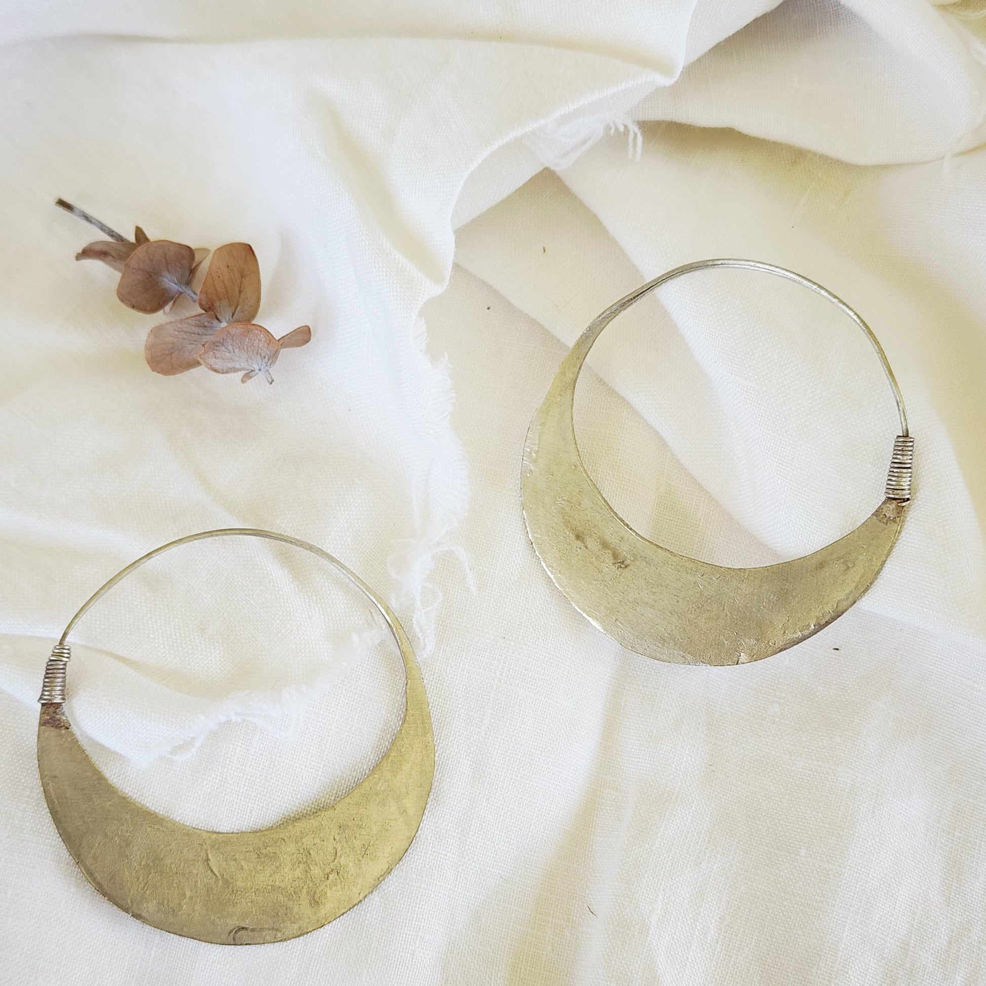 Back view of the Silver Strays etched crescent hoops, showing the clasp and desert-worn patina.