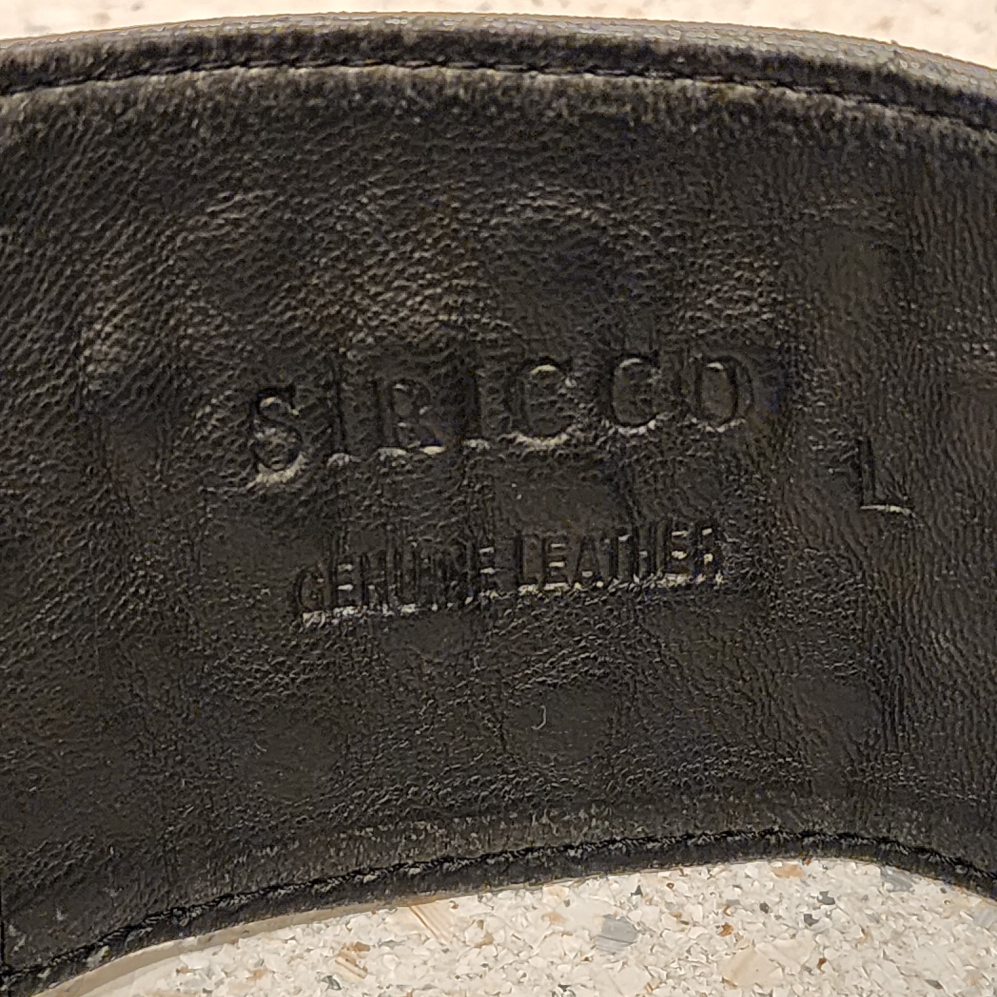 Close up of Sirocco leather belt showing the brand print and the genuine leather stamp.