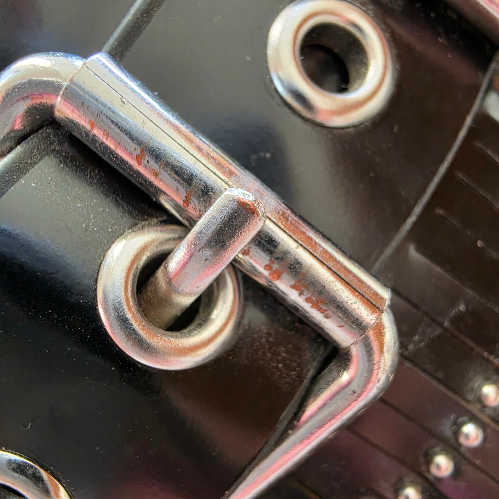 Close-up showing wear and light rusting on hardware of Sol Sana Sadie slides