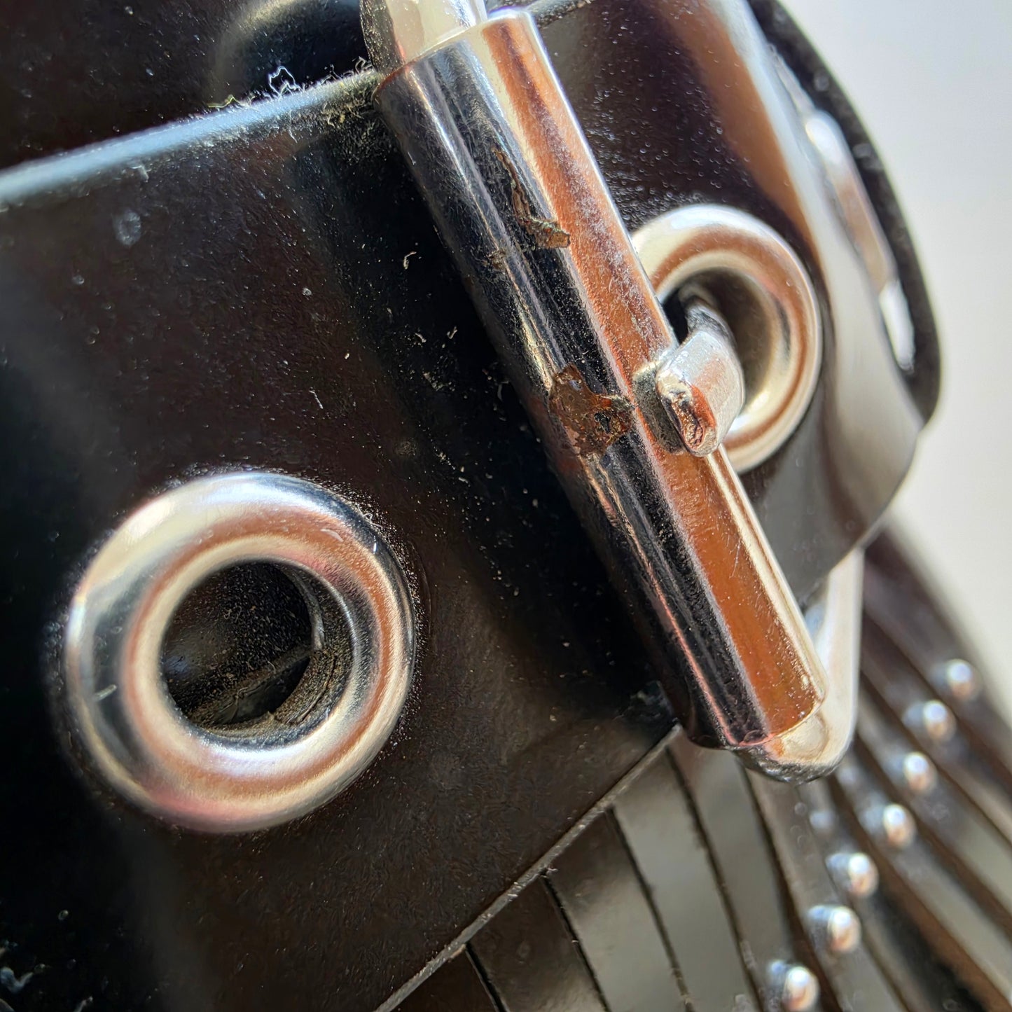 Close-up showing wear and light rusting on hardware of Sol Sana Sadie slides