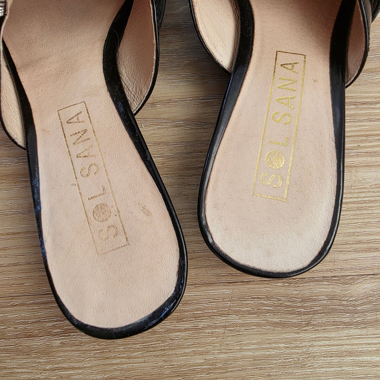 Inner sole of Sol Sana Sadie slides with gold logo and light wear marks