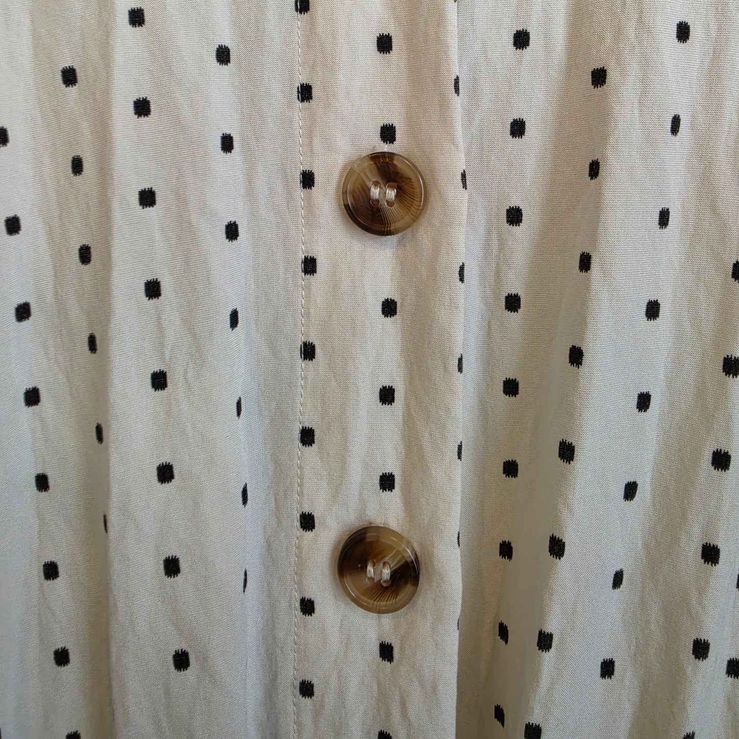 Close up of the back button details in varying brownds on the back of the ST MRLO Maya Playsuit