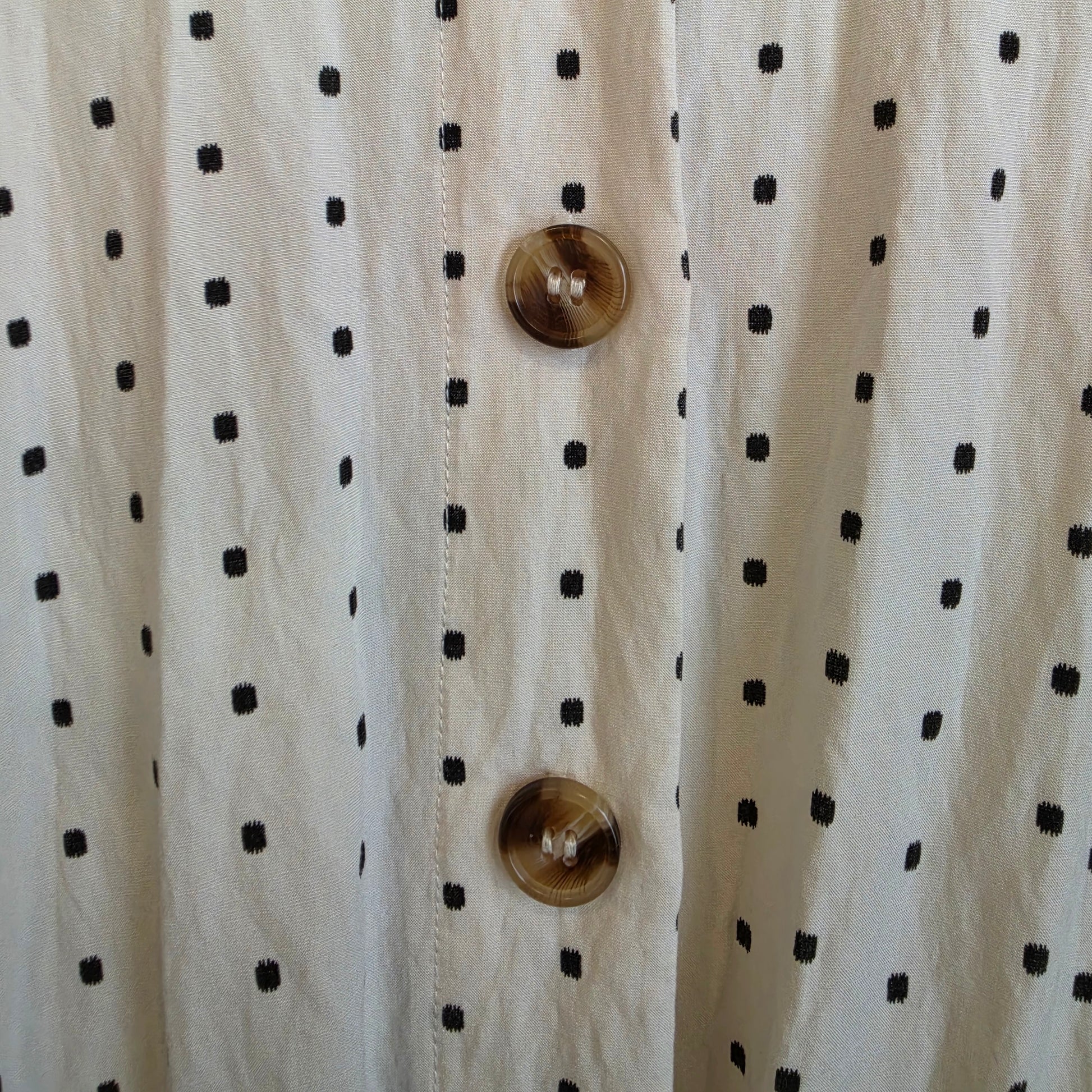 Close up of the back button details in varying brownds on the back of the ST MRLO Maya Playsuit