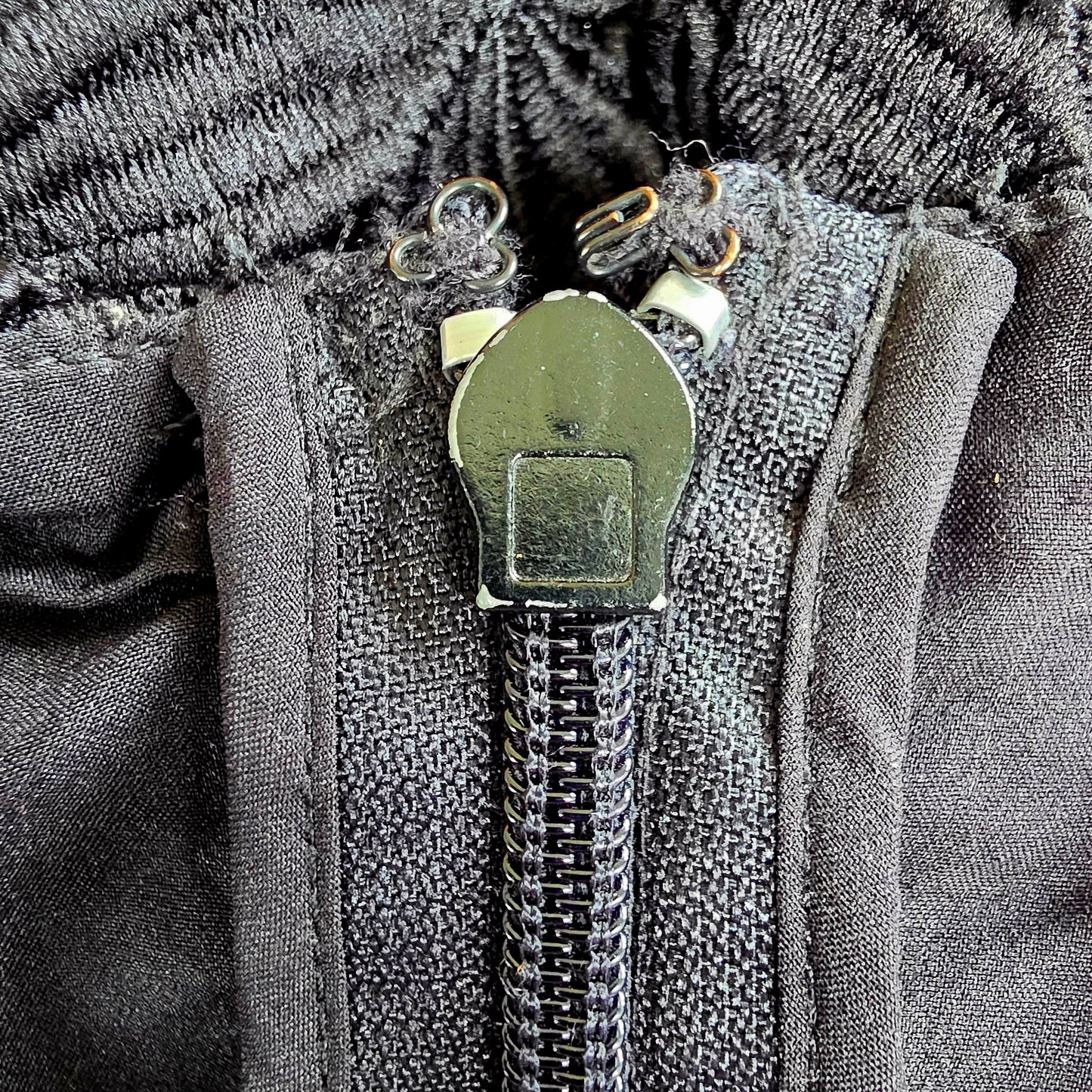 Close up of the zip on the Stone Cold Fox Saint Jumpsuit, showing the condition with slight chipping anf dicolouration of the hook and eye closure.