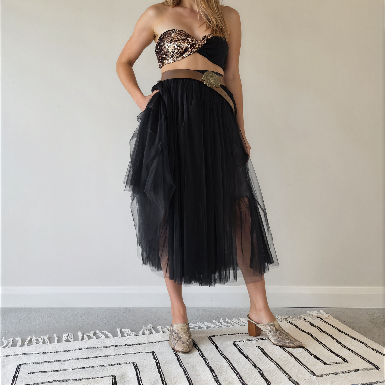Front view of the Style Workroom black Tulle midi skirt worn with a sequin crop top and western belt.