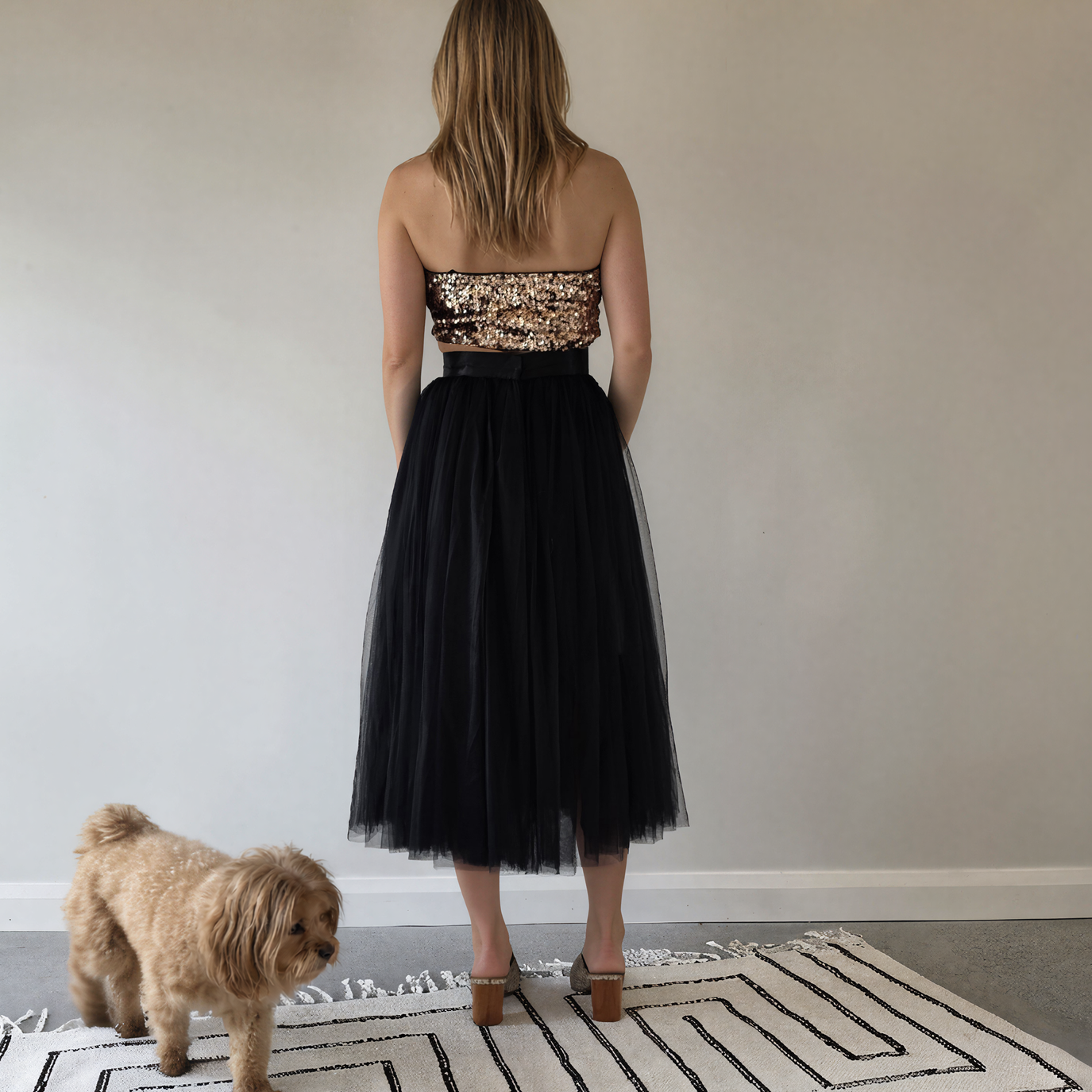 Back view of woman wearing the Style Workroom black tutu skirt, showing the tulle and midi length.