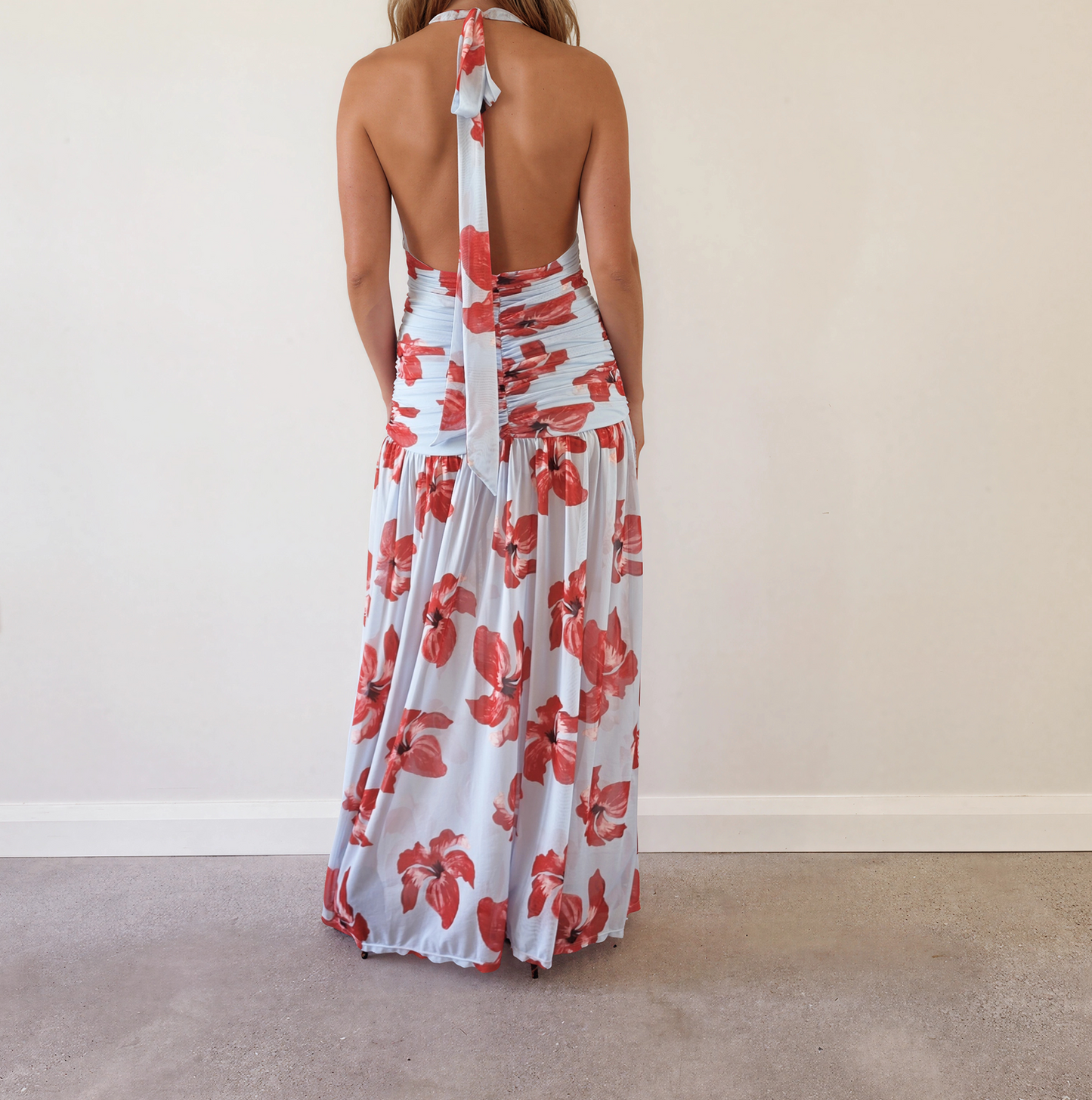 Back view of the Suboo Chloe floral halter maxi dress with open back and halter tie.