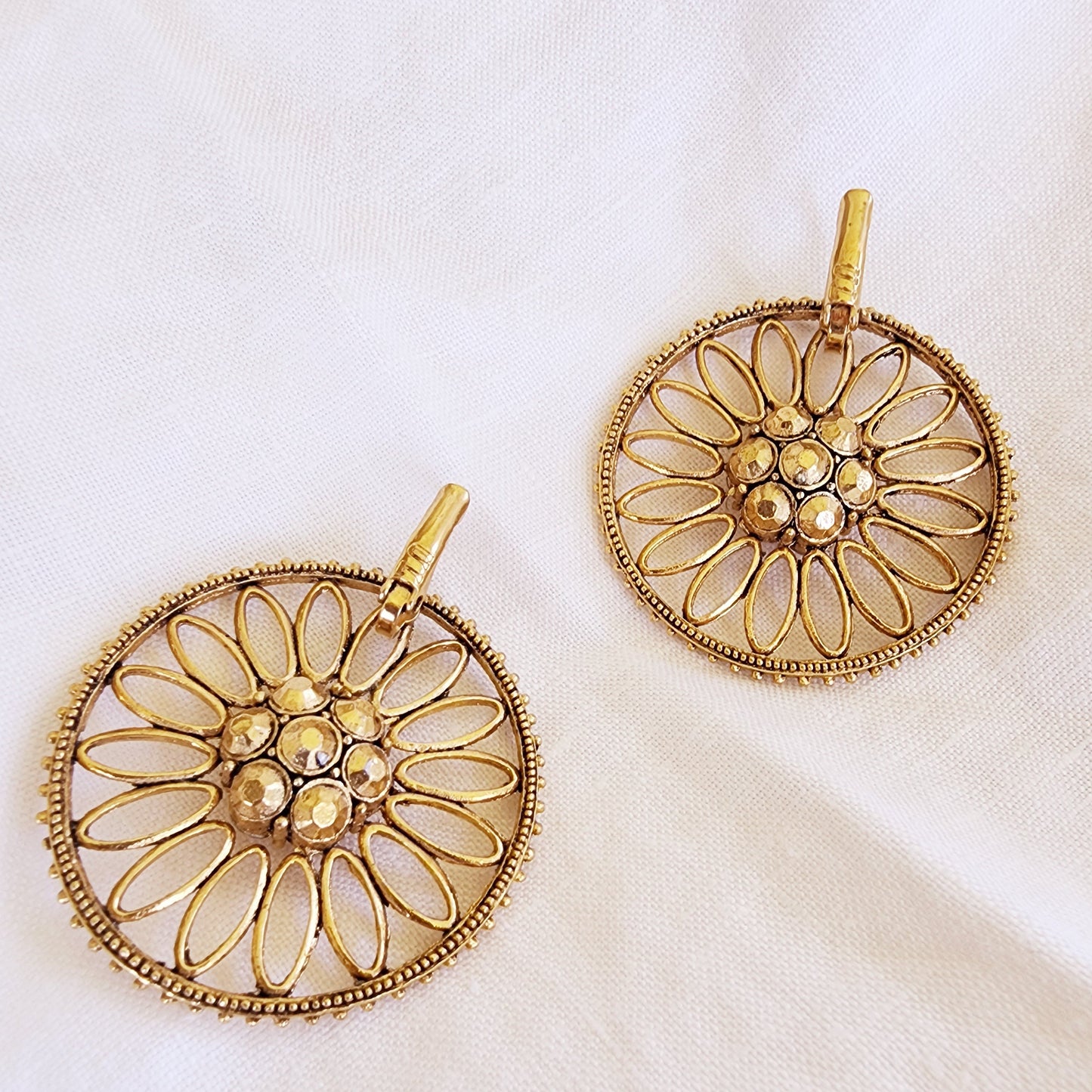Back view of the Sunflare earrings showing the clasp and gold-tone finish.