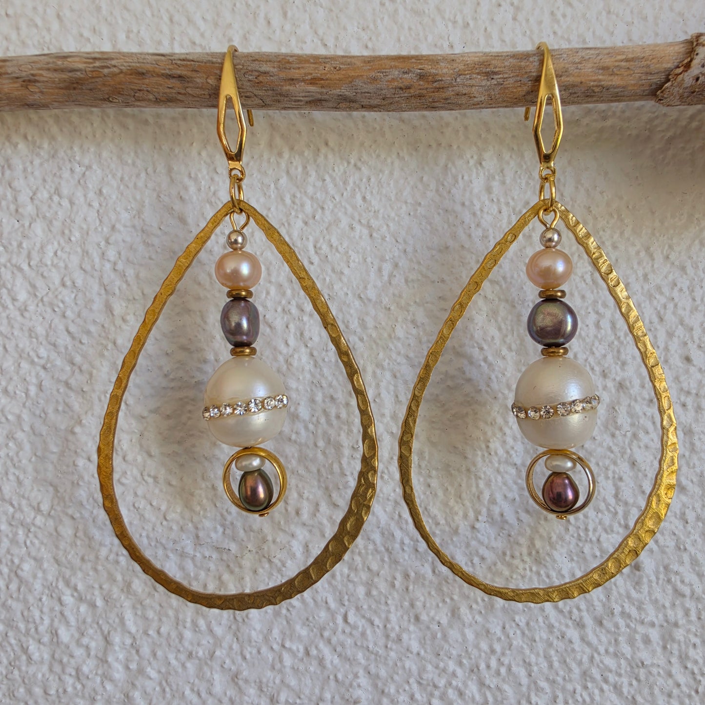 Front view of the Versamel earrings, showing the different coloured pearls, diamantes, brass and gold plated components