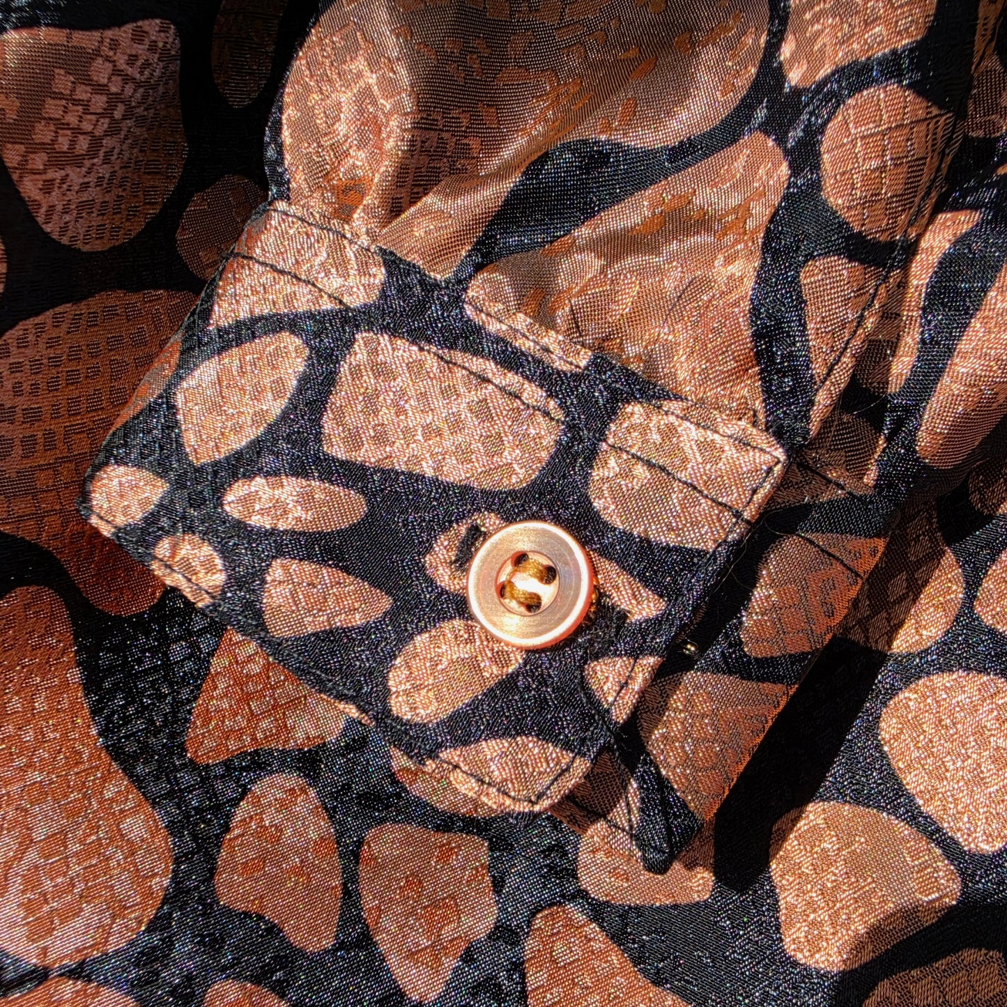 close up of the button sleeve on the Vintage Katies animal print blouse