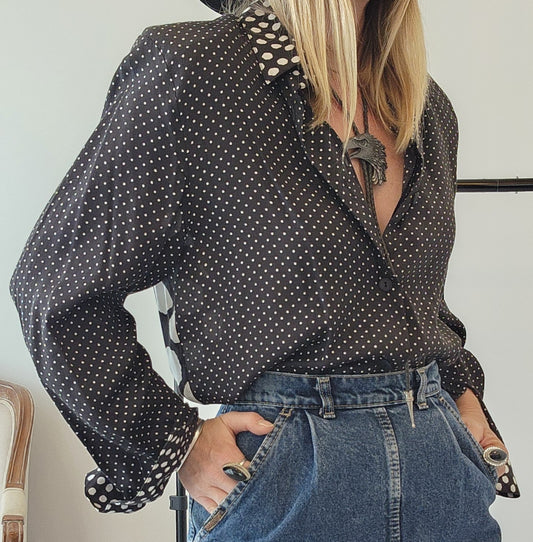 Model wearing a 90s vintage multi-pattern button-up shirt in black & white polka dot in Size 10 