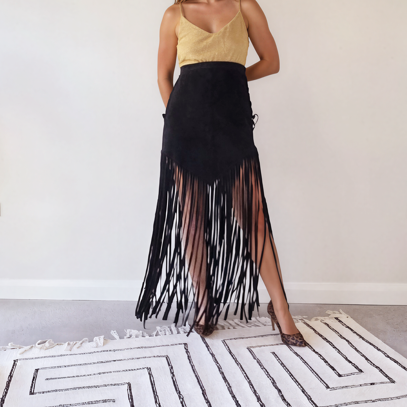 Front view of the vintage long fringe suede skirt, showing the V style hem falling into ankle length fringe.