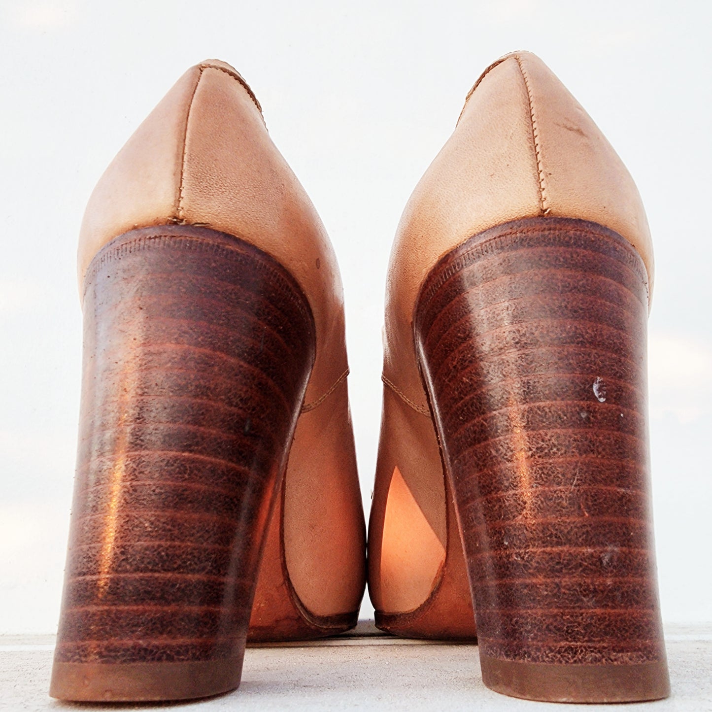 Rear angle of the vintage Pollini oxford heels showing the stacked heel and light wear to the heel area.