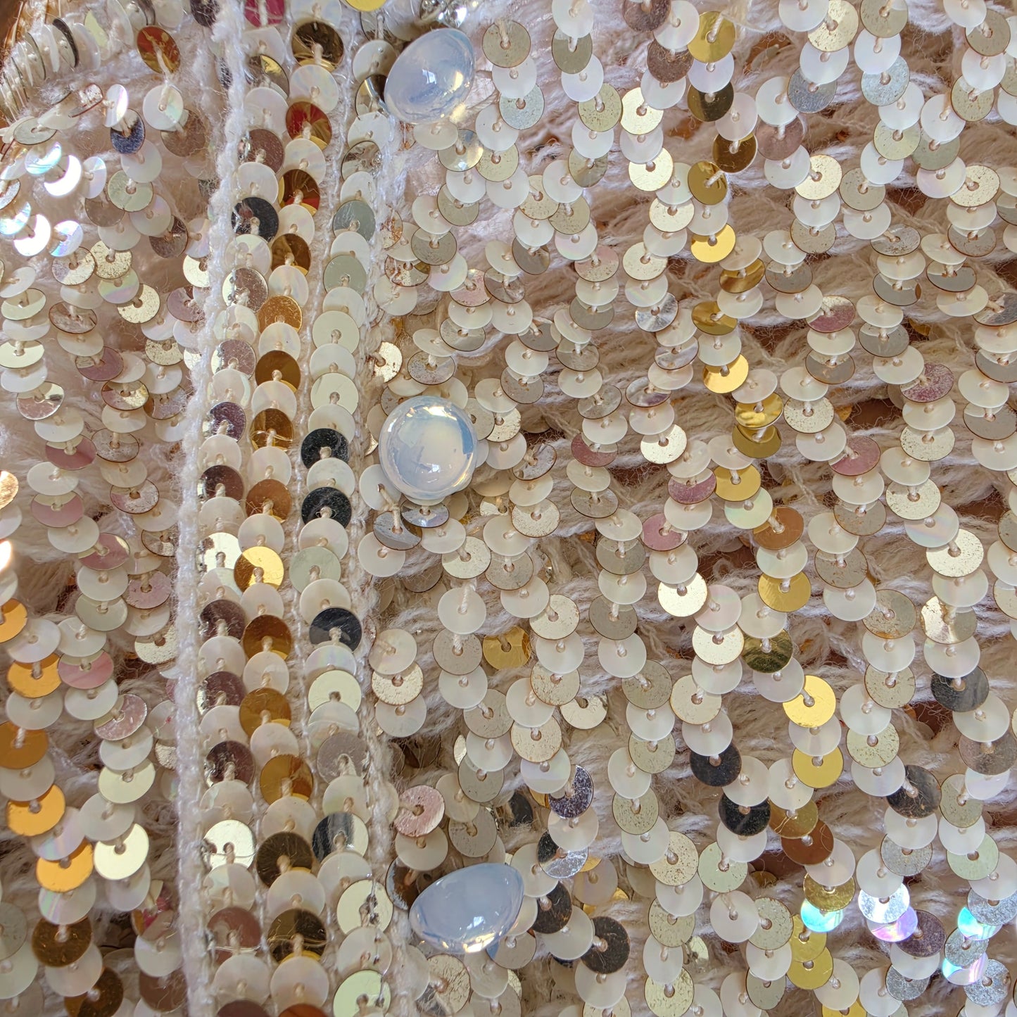 Close up view of the opalecent buttons on the vintage sequin jacket