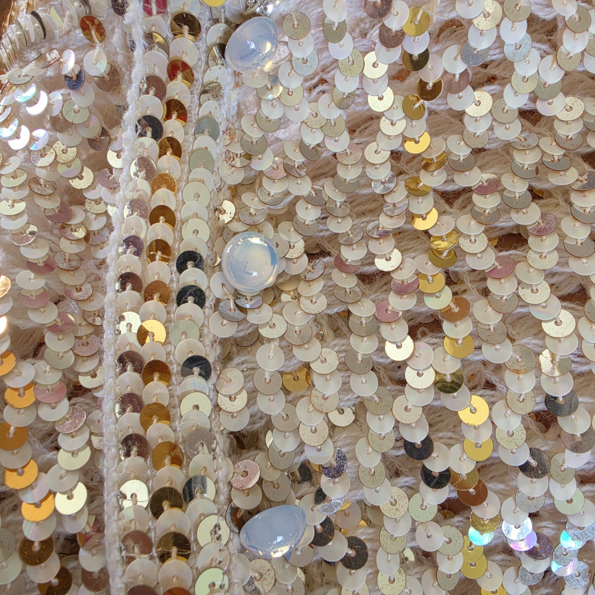 Close up view of the opalecent buttons on the vintage sequin jacket