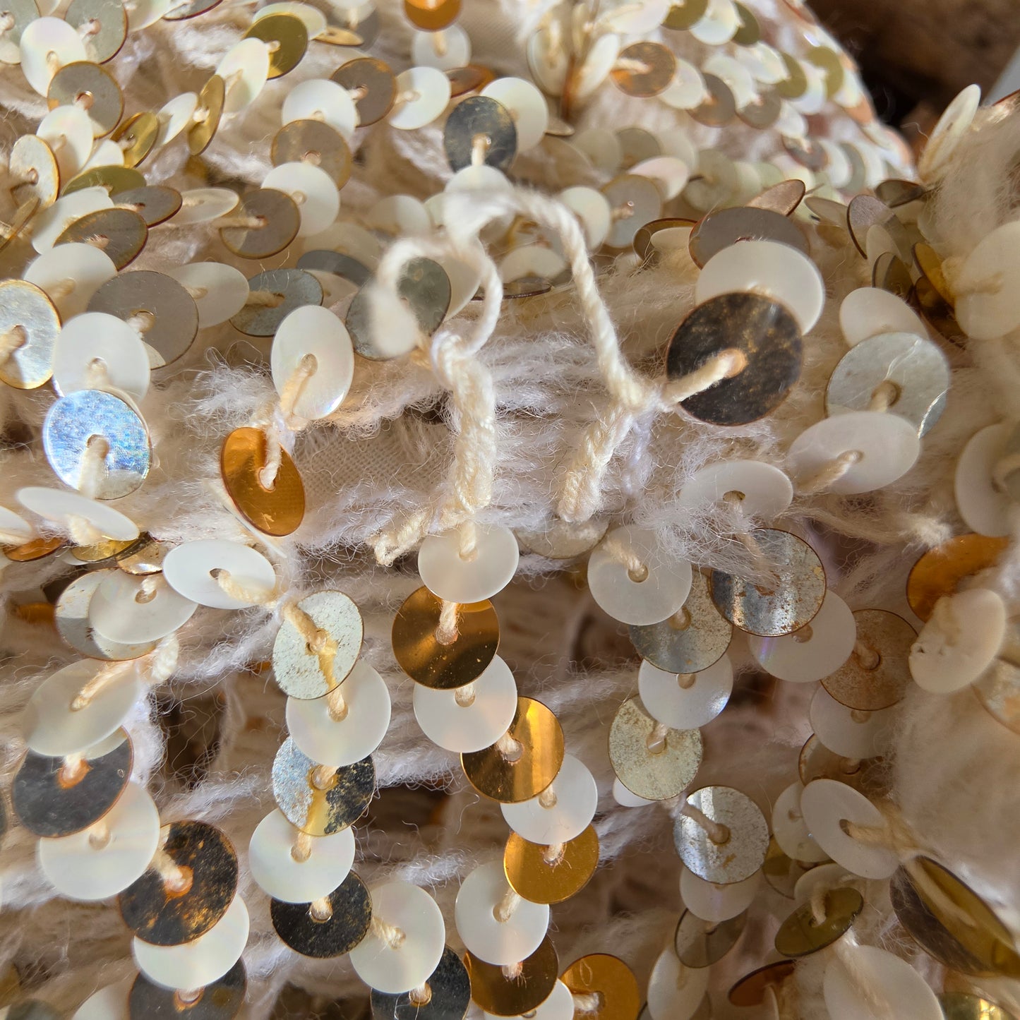 Close up view of the vintage sequin dinner jacket showing the seam with a couple of missing sequins