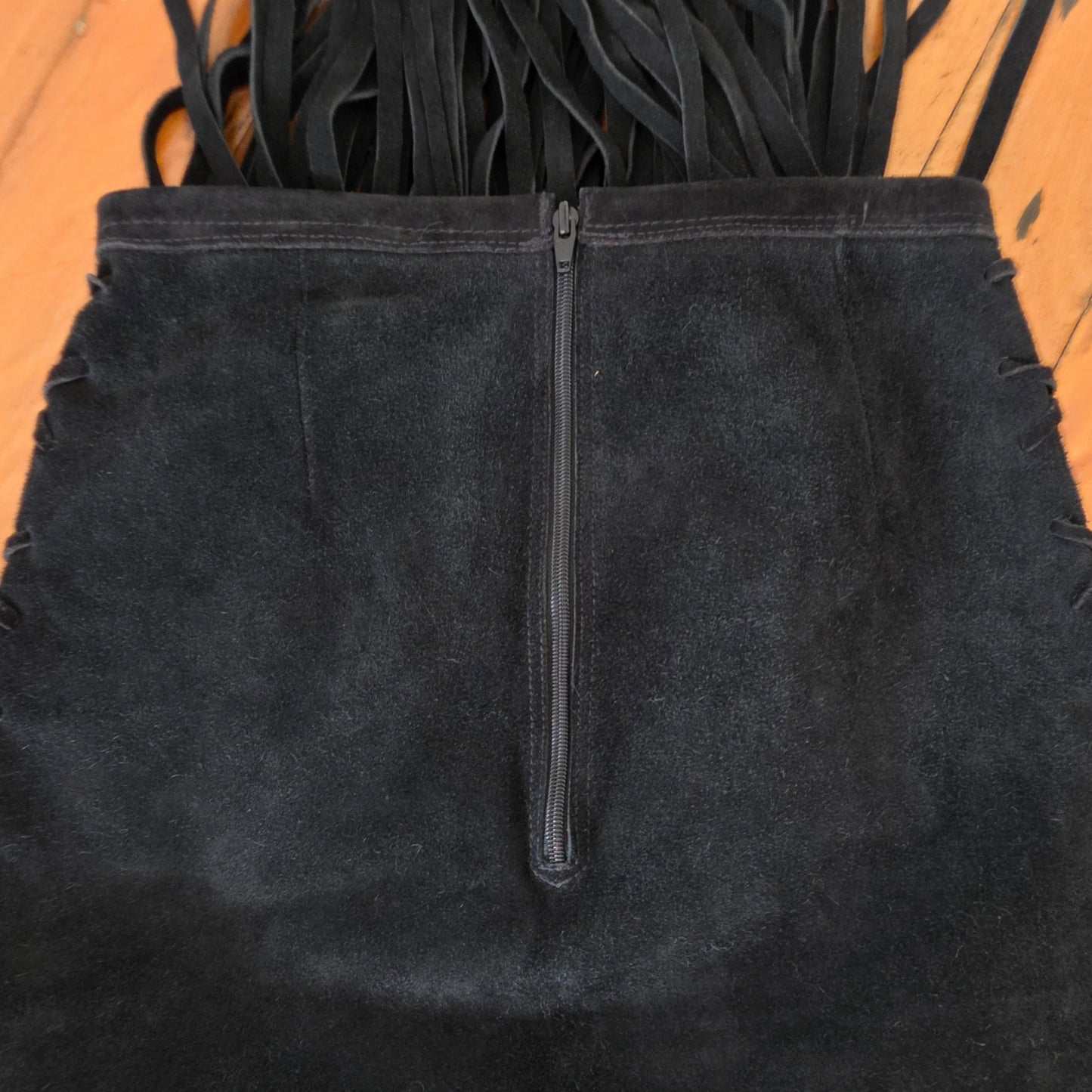 Close up of the back of the Vintage suede fringe skirt, showing the wear and side ties.