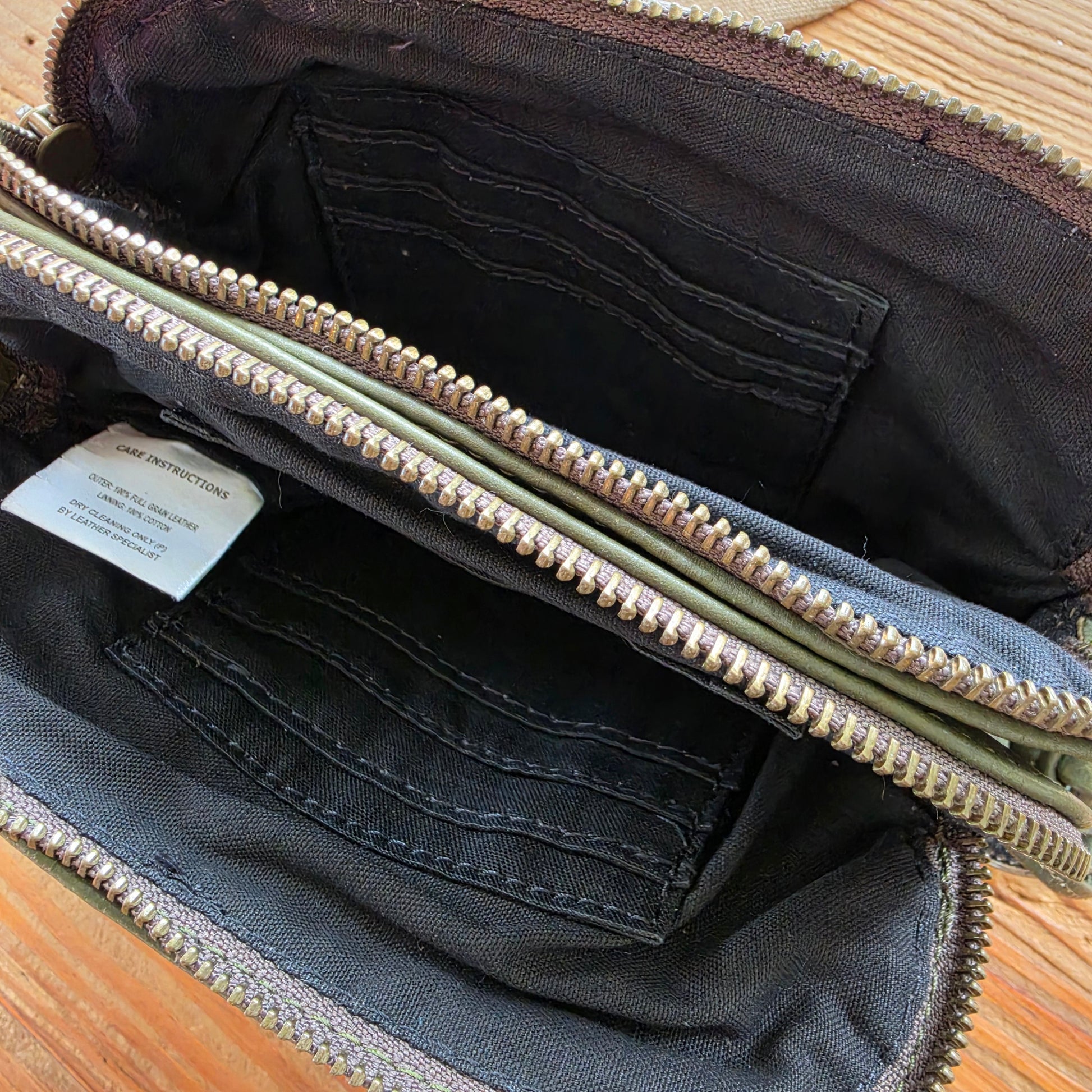 Interior of The Wanderers Venetian wallet showing card slots and zip compartment