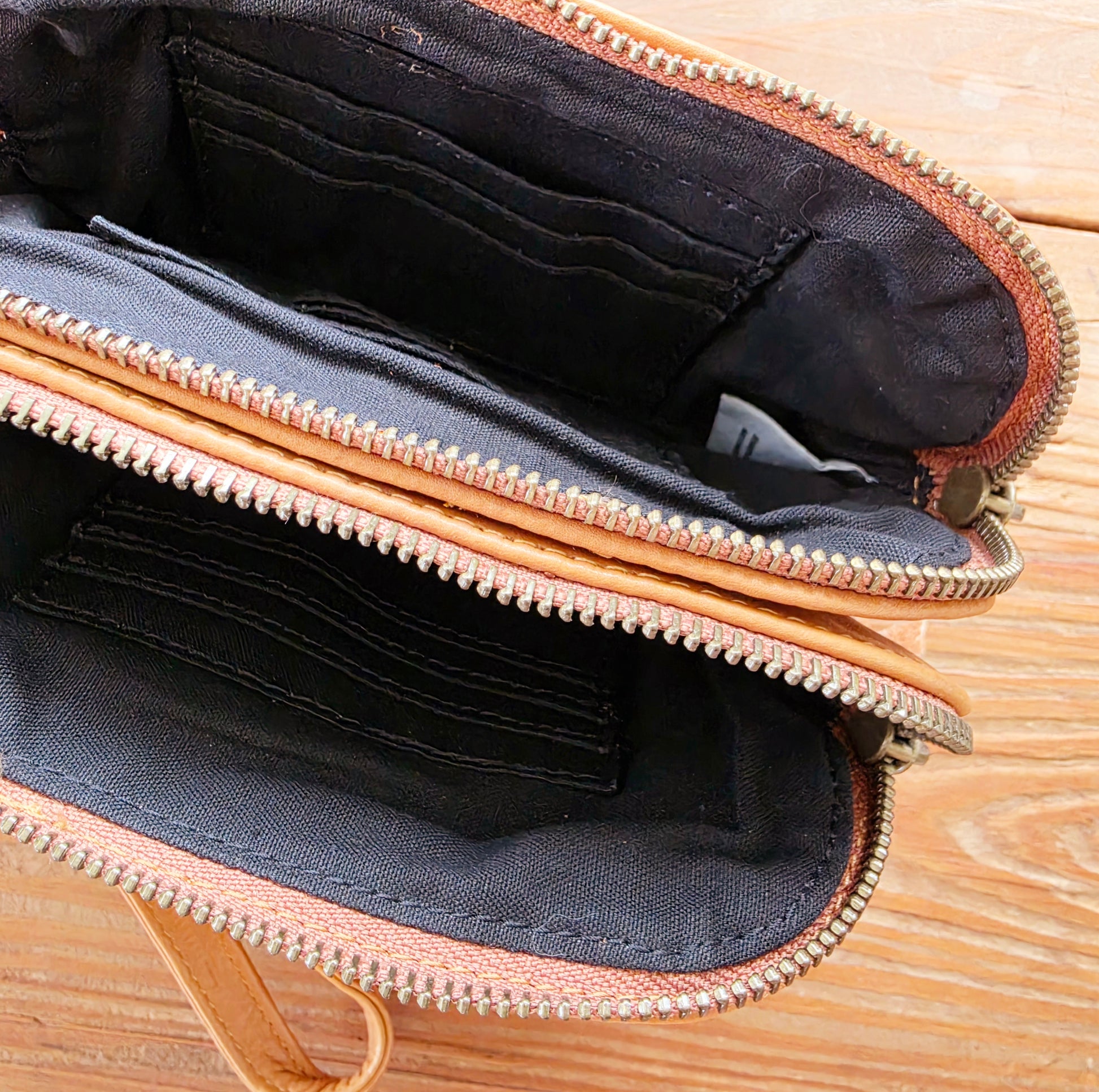 Interior of The Wanderers Venetian wallet in tan showing card slots and zip compartment