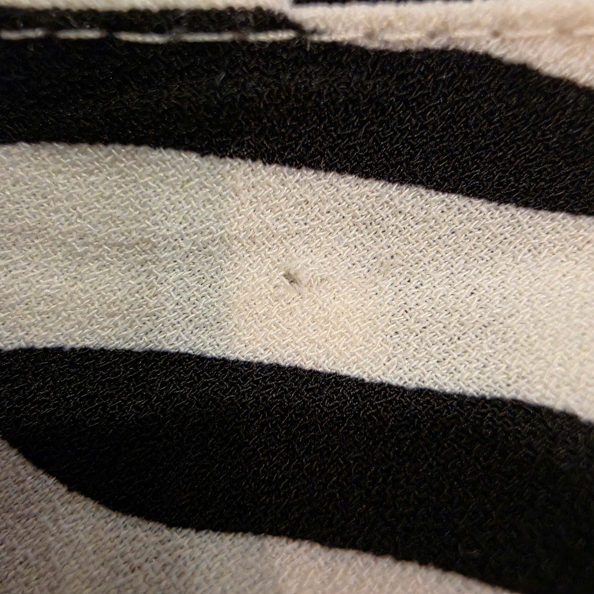 Image showing a small hole in the inside fabric of the zebra midi dress