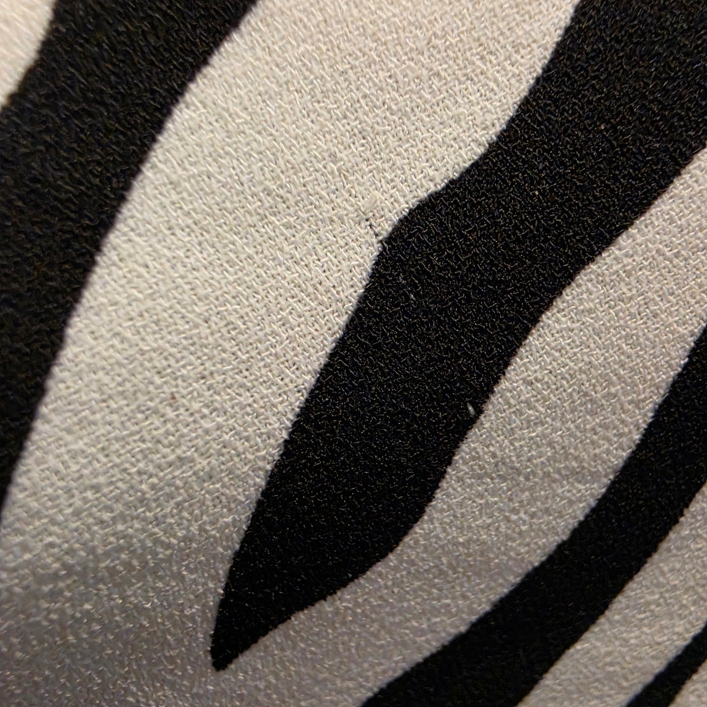 close up view of a small pull in the fabric on the zebra midi dress