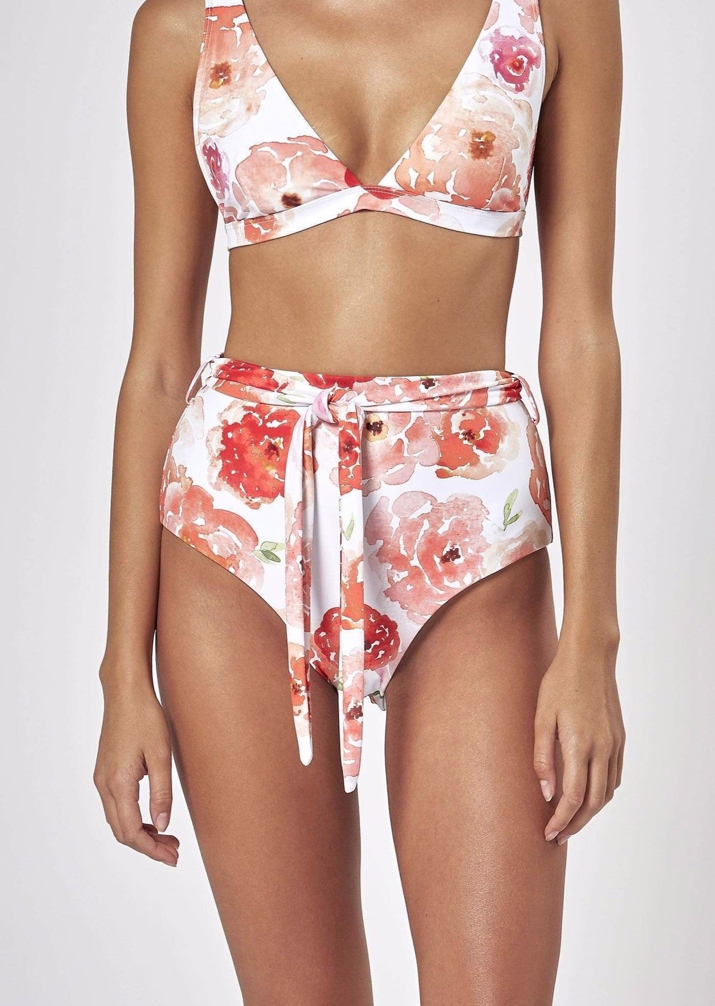 Charlie Holiday white bikini set with coral watercolour floral print and high-waisted wrap tie bottoms.