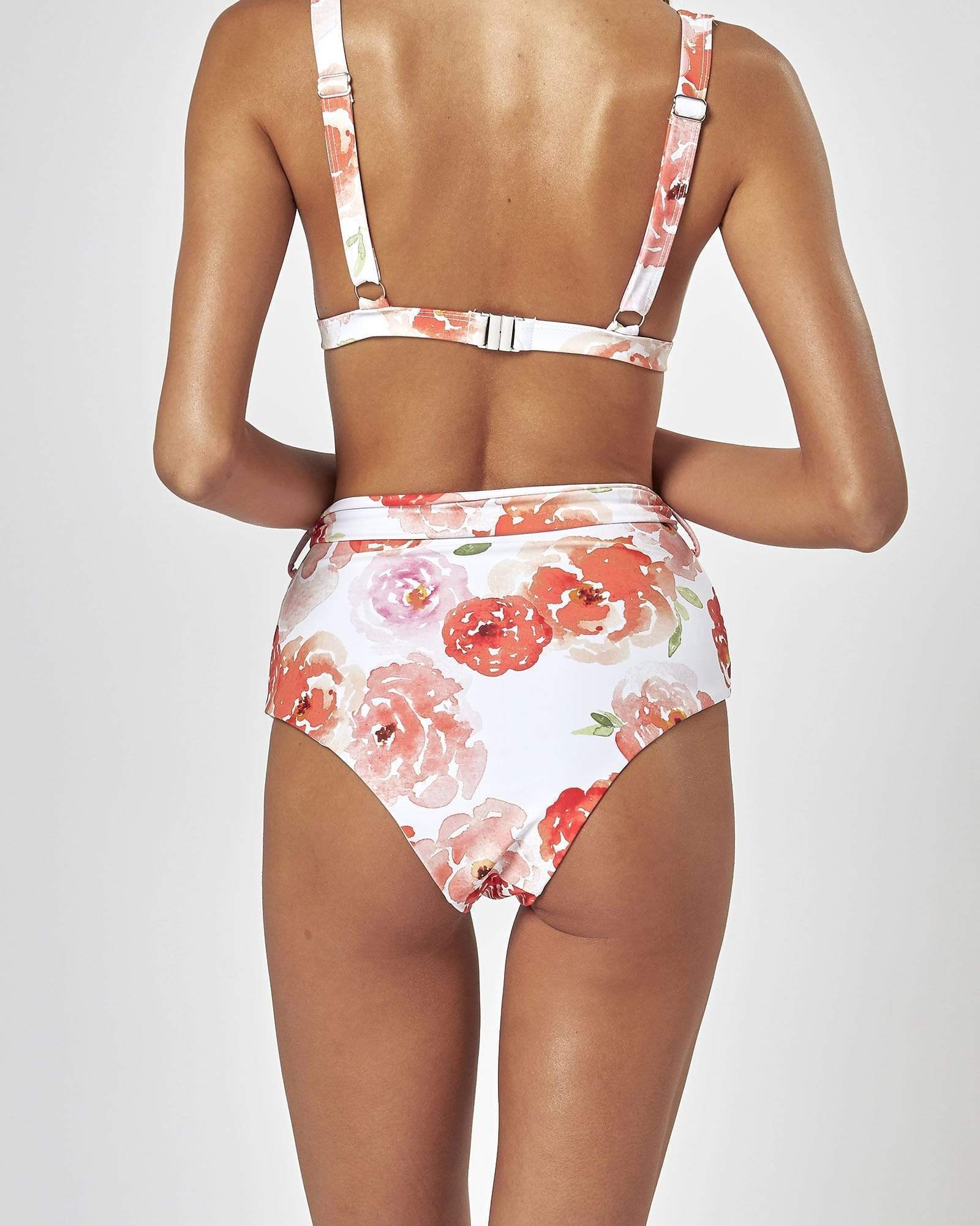 Charlie Holiday triangle bikini top with coral and blush floral print and adjustable straps.