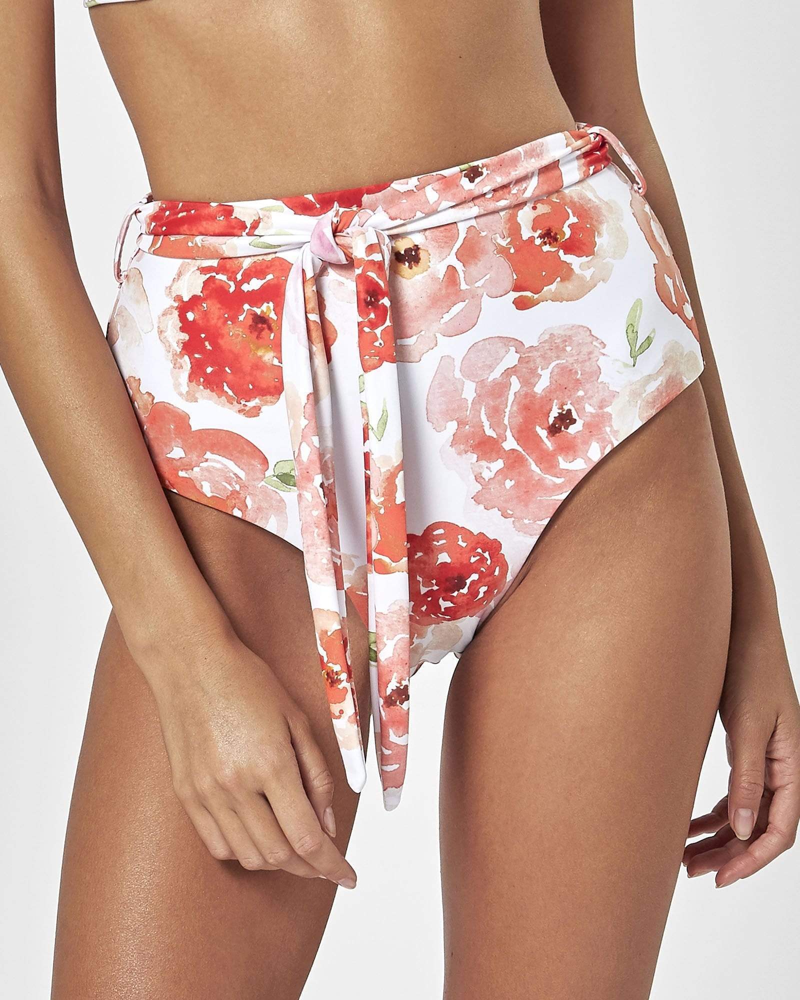 Charlie Holiday high-waisted bikini bottoms with coral floral print and wrap tie detail.